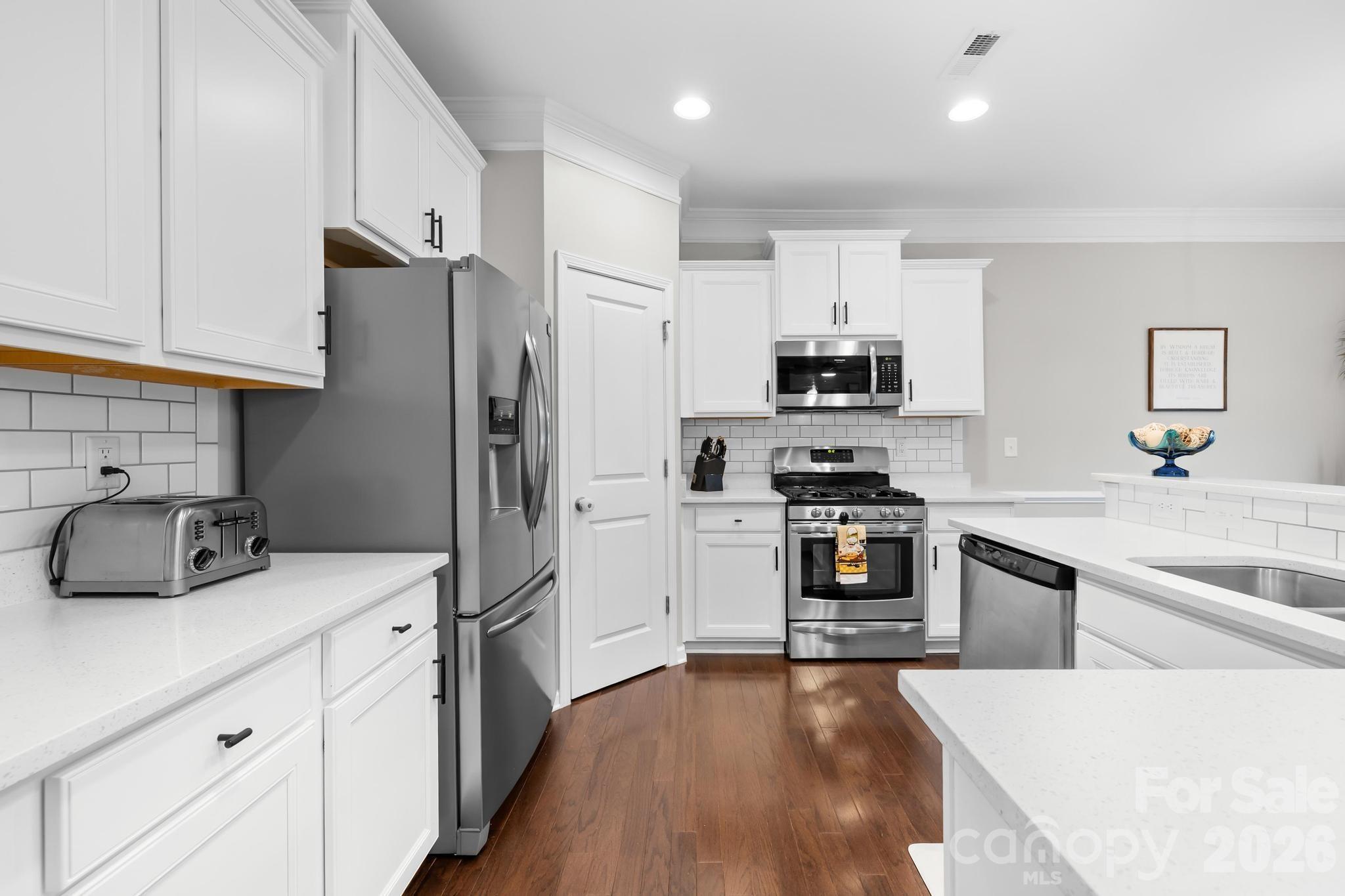 5020 Fenwick Court Lancaster, SC 29720 - Photo 2 of 46 a kitchen with granite countertop a refrigerator stove and sink