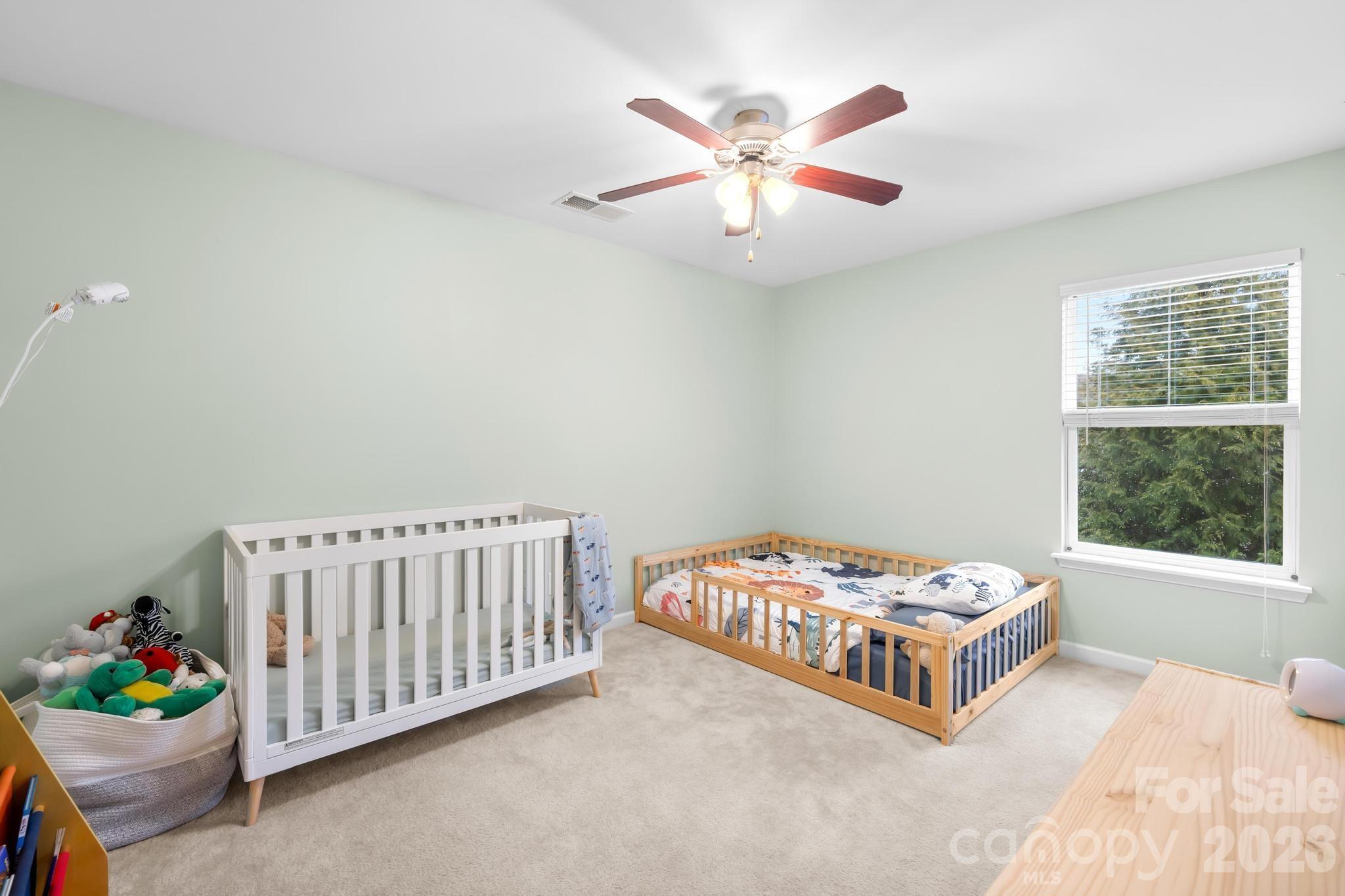 5020 Fenwick Court Lancaster, SC 29720 - Photo 22 of 46 a bedroom with a bed and a chandelier
