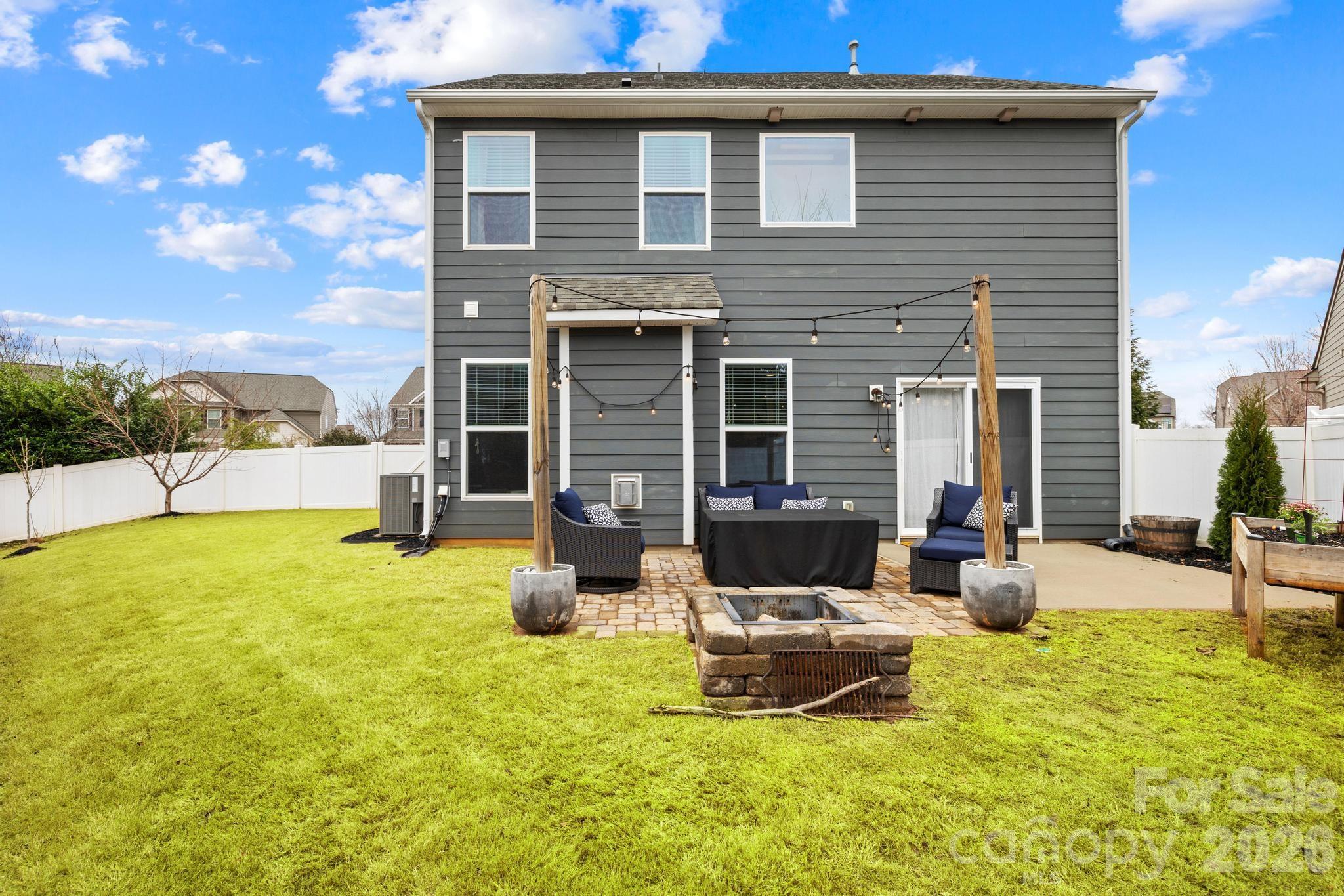 5020 Fenwick Court Lancaster, SC 29720 - Photo 5 of 46 a backyard of a house with table and chairs