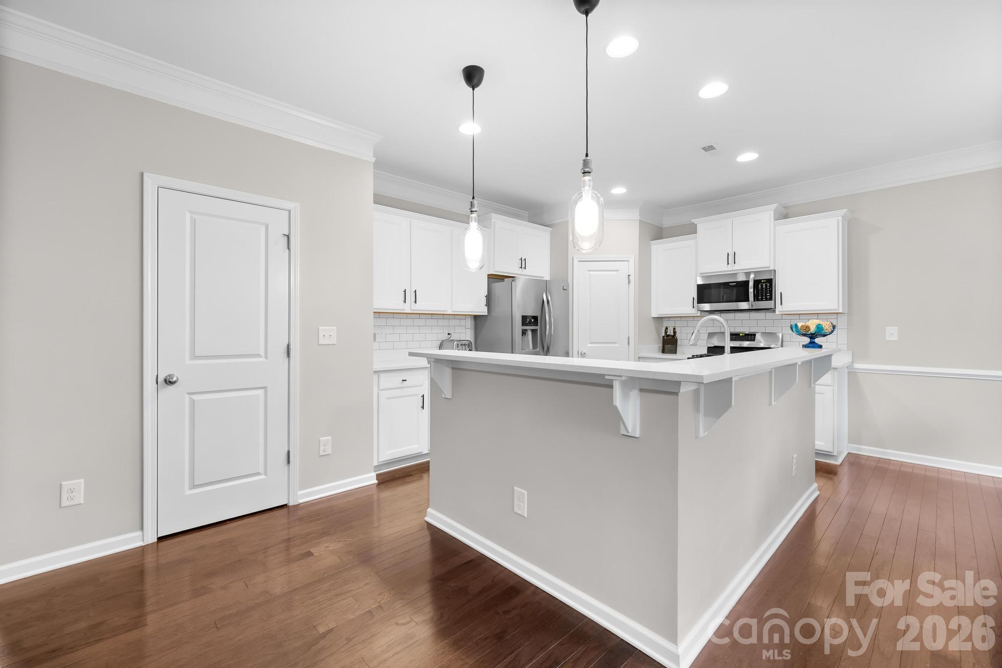 5020 Fenwick Court Lancaster, SC 29720 - Photo 9 of 46 a kitchen with kitchen island white cabinets and refrigerator