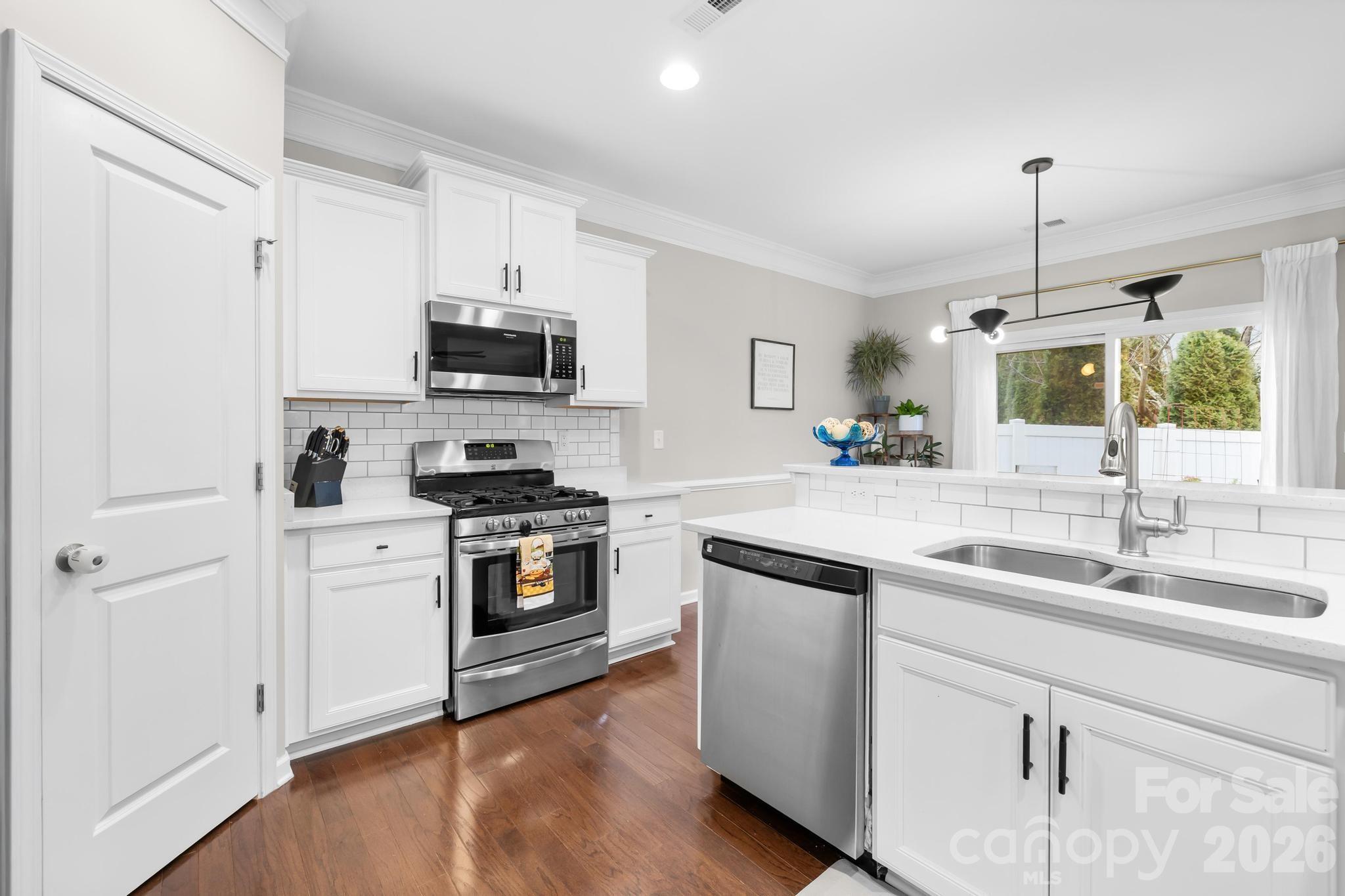 5020 Fenwick Court Lancaster, SC 29720 - Photo 10 of 46 a kitchen with a sink stove and cabinets