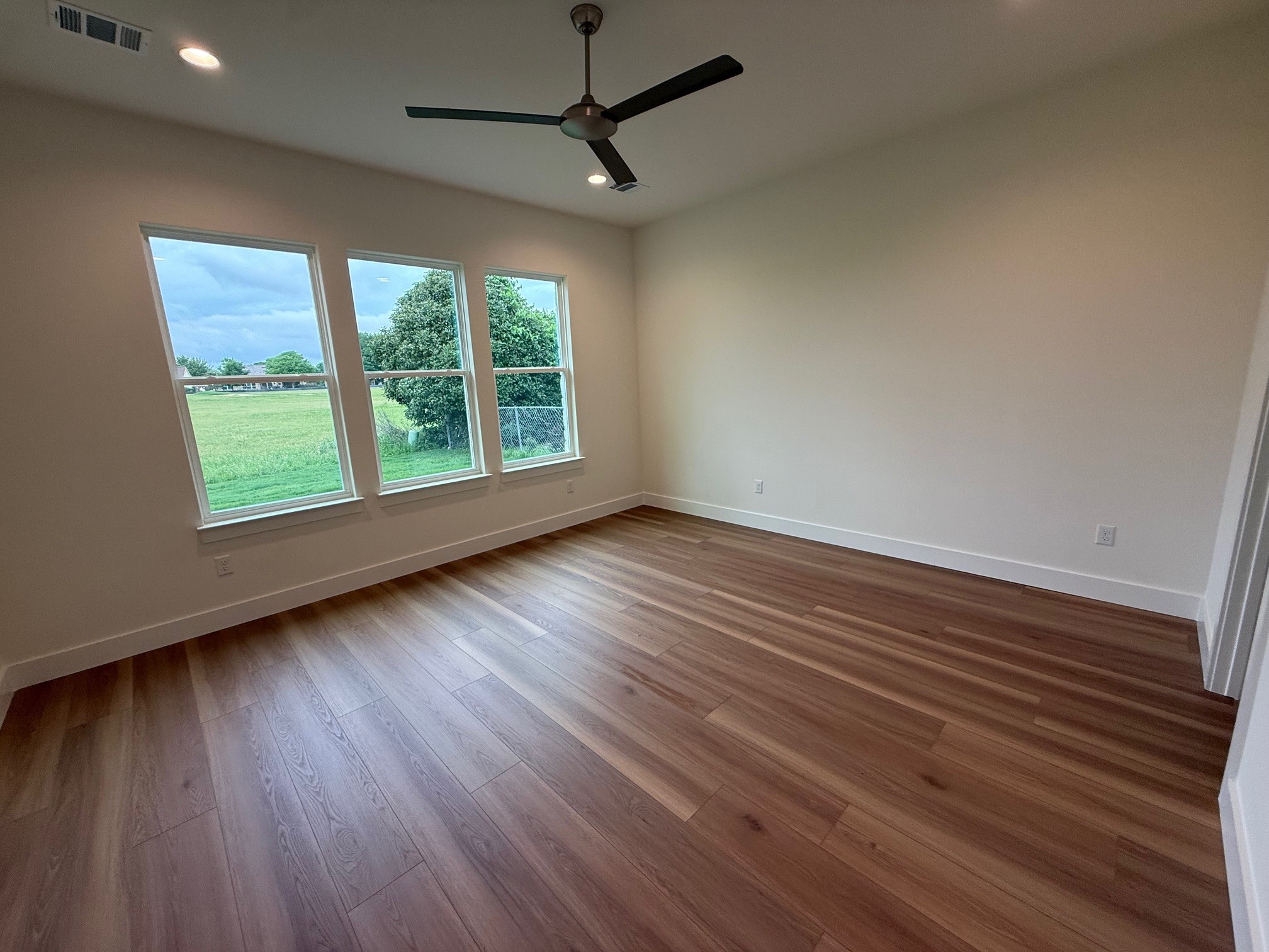 110 Firestone Place Meadowlakes, TX 78654 - Photo 9 of 18 Wood-finish flooring throughout, complemented by three large windows overlooking a green expanse