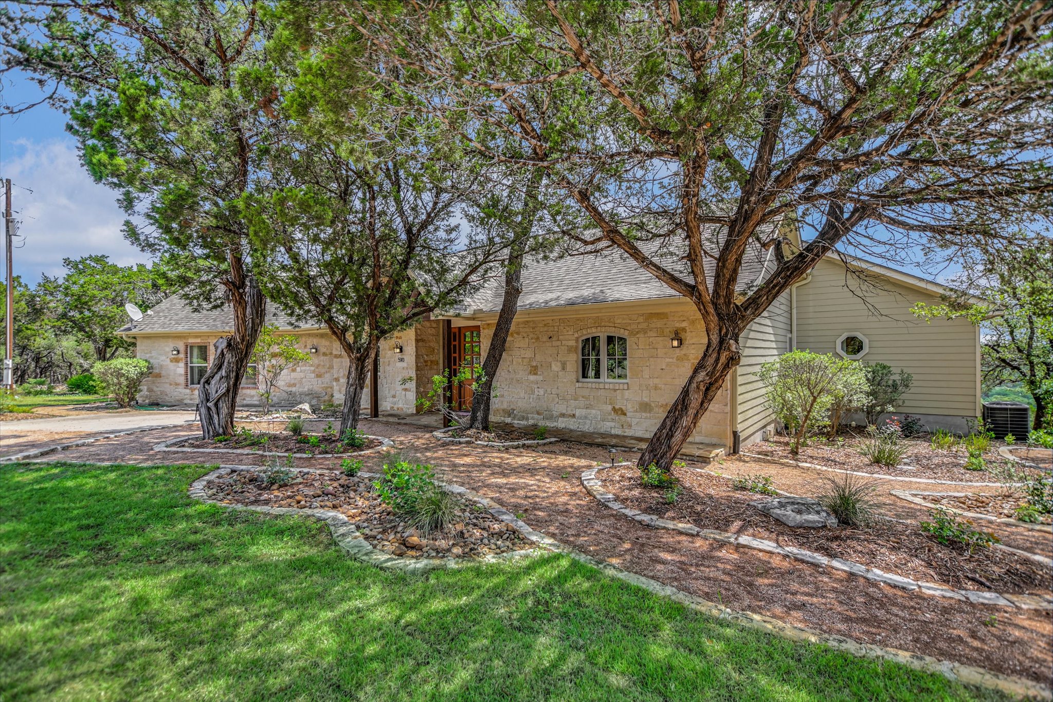 590 Rancho Grande Drive Wimberley, TX 78676 - Photo 1 of 30 a view of a house with backyard and trees