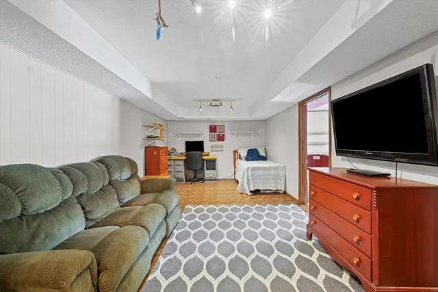 a bedroom with furniture and flat screen tv