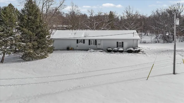 a view of a house with a yard and covered with snow