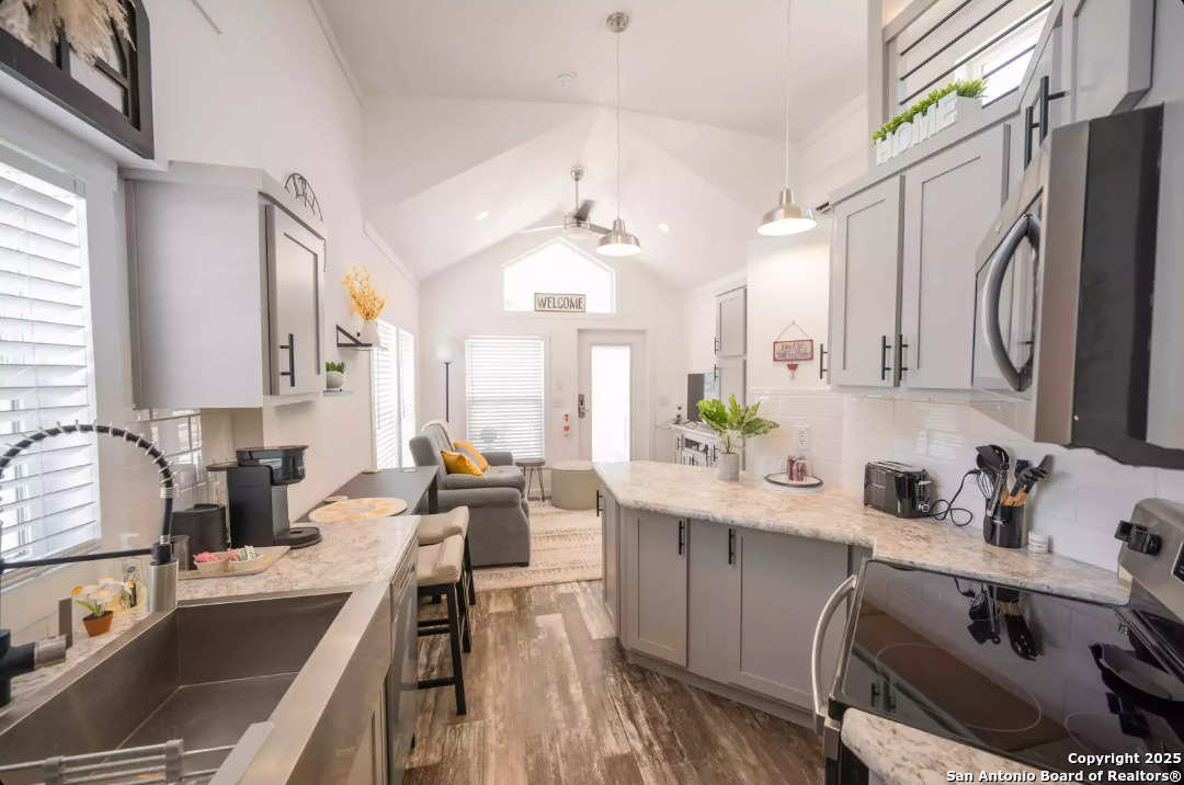 5386 Ranch Road 1376, Unit 114 Fredericksburg, TX 78624 - Photo 11 of 29 a kitchen with a sink stove and cabinets