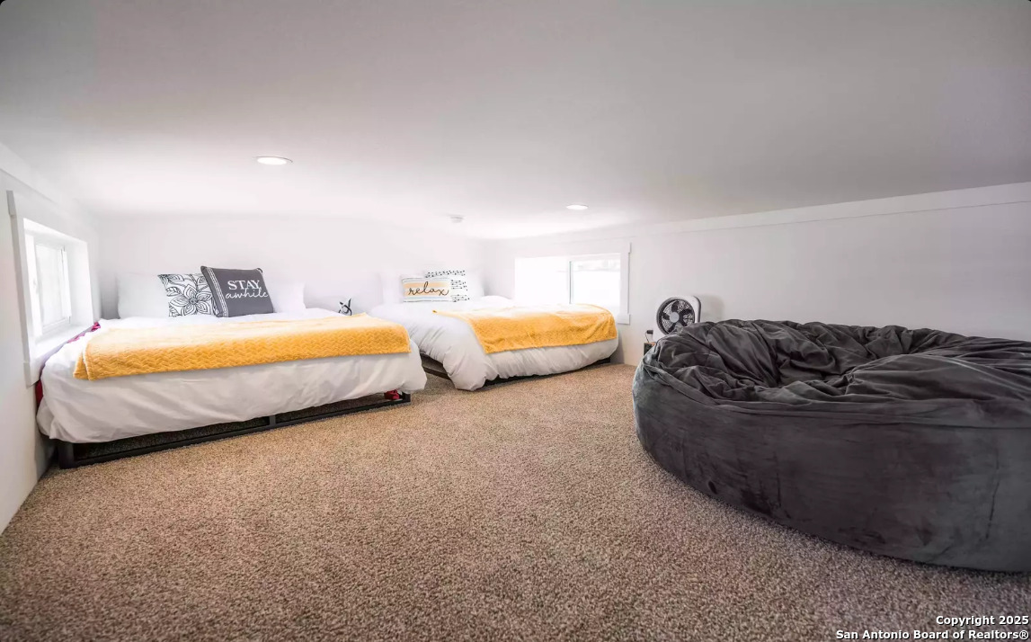 5386 Ranch Road 1376, Unit 114 Fredericksburg, TX 78624 - Photo 15 of 29 a spacious bedroom with two beds and a couch