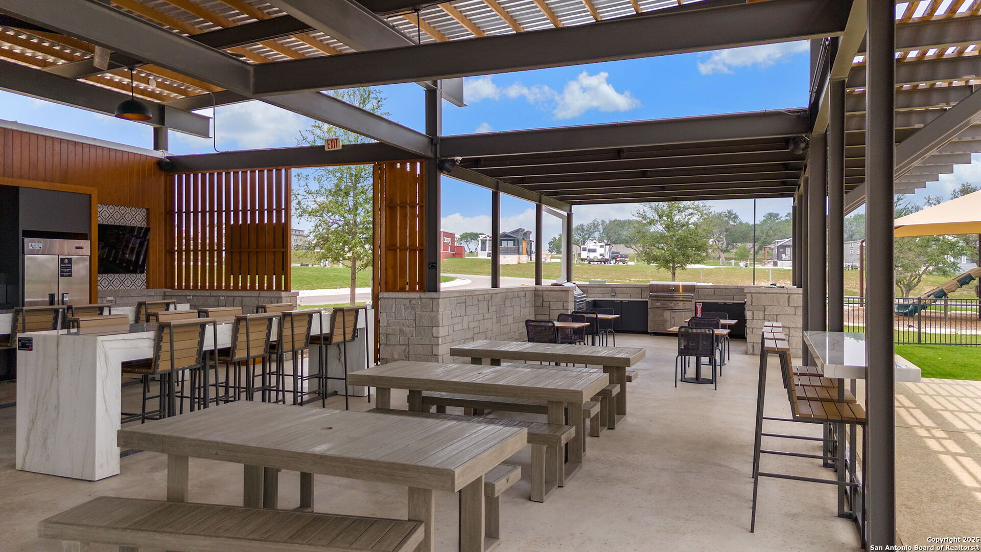 5386 Ranch Road 1376, Unit 114 Fredericksburg, TX 78624 - Photo 23 of 29 a view of a dining room with furniture and floor to ceiling window