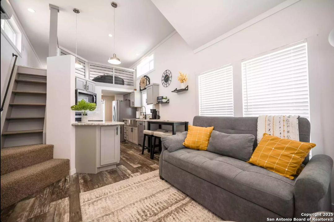 5386 Ranch Road 1376, Unit 114 Fredericksburg, TX 78624 - Photo 6 of 29 a living room with furniture and wooden floor