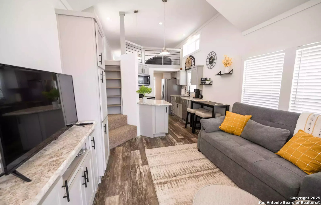 5386 Ranch Road 1376, Unit 114 Fredericksburg, TX 78624 - Photo 7 of 29 a living room with furniture and a flat screen tv