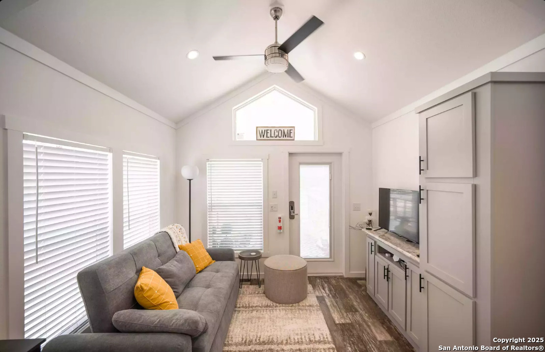 5386 Ranch Road 1376, Unit 114 Fredericksburg, TX 78624 - Photo 8 of 29 a living room with furniture a large window and a chandelier