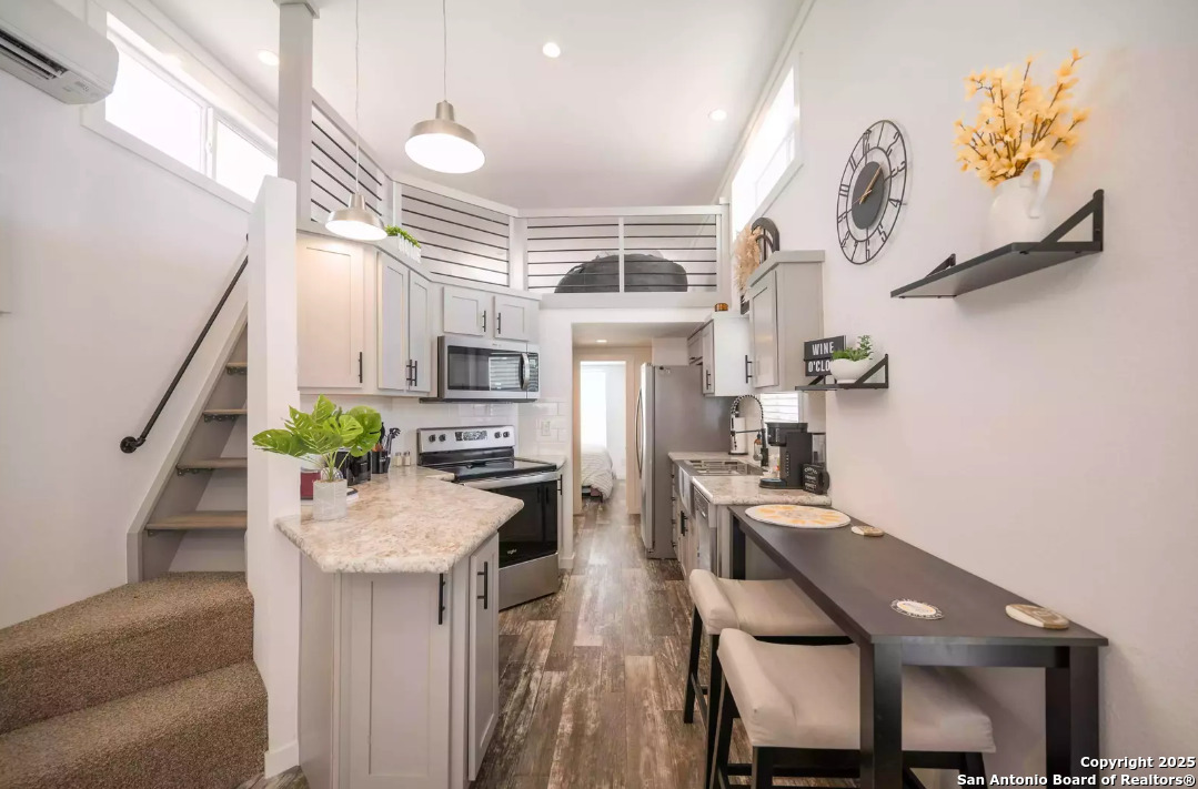 5386 Ranch Road 1376, Unit 114 Fredericksburg, TX 78624 - Photo 9 of 29 a kitchen with sink refrigerator and microwave