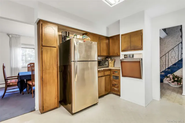 a kitchen with stainless steel appliances a refrigerator and a stove