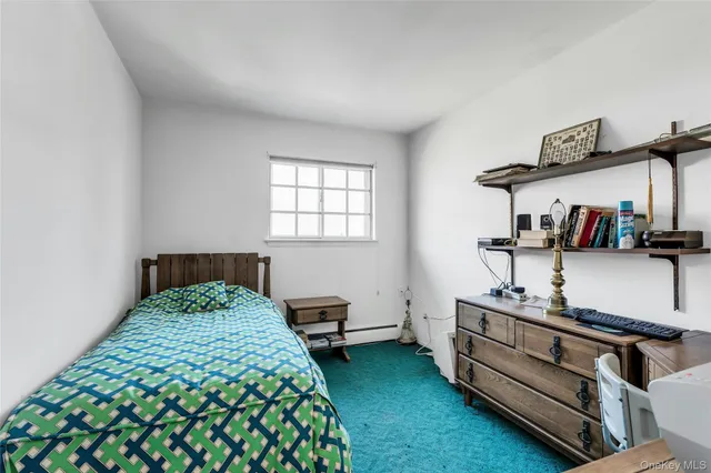 a bedroom with bed and a window