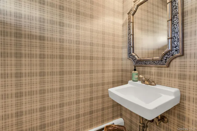 a bathroom with a sink a mirror and a shower