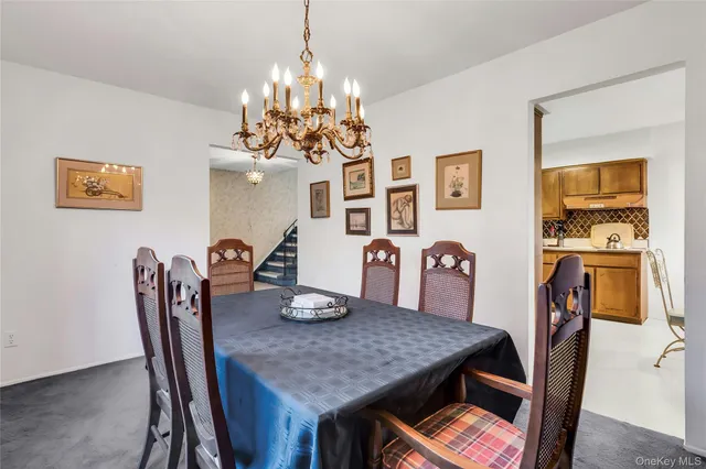 a view of a dining room with furniture and chandelier