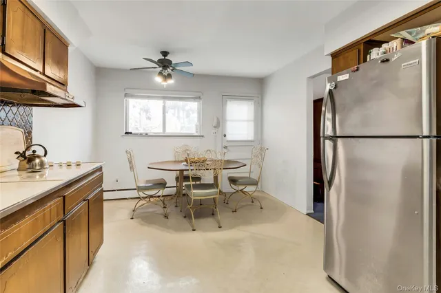 a kitchen with stainless steel appliances granite countertop a refrigerator a sink a stove and island