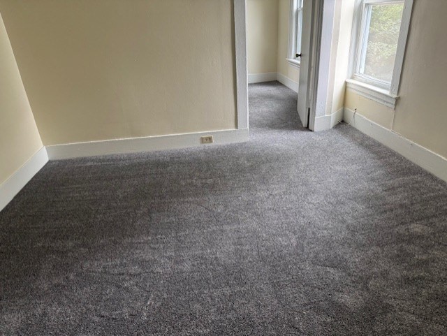 43 Nesmith Street, Unit 7 Lowell, MA 01852 - Photo 5 of 9 an empty room with windows