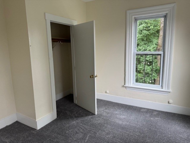 43 Nesmith Street, Unit 7 Lowell, MA 01852 - Photo 6 of 9 an empty room with windows and closet