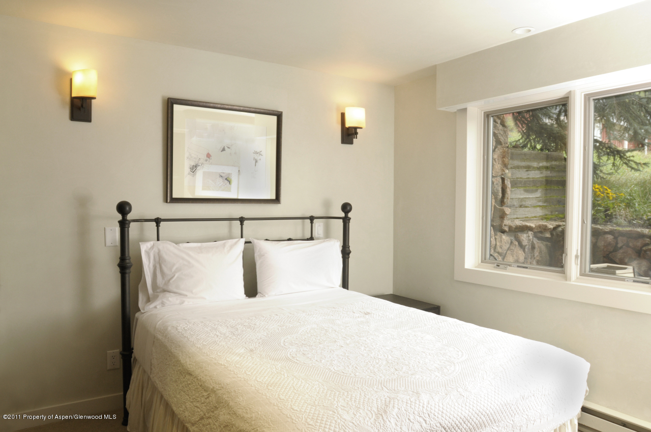 701 South Monarch Street, Unit 2 Aspen, CO 81611 - Photo 10 of 13 a bedroom with a large bed and a window