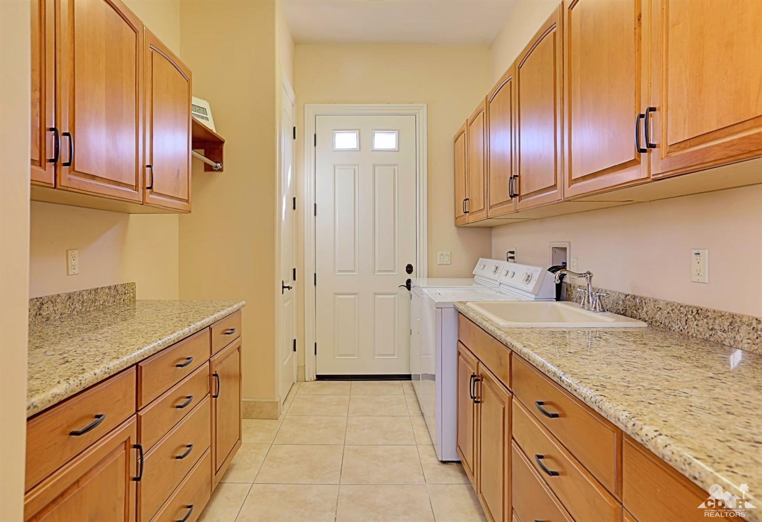 36844 Palm View Road Rancho Mirage, CA 92270 - Photo 36 of 48 a kitchen with granite countertop stainless steel appliances a sink stove and cabinets