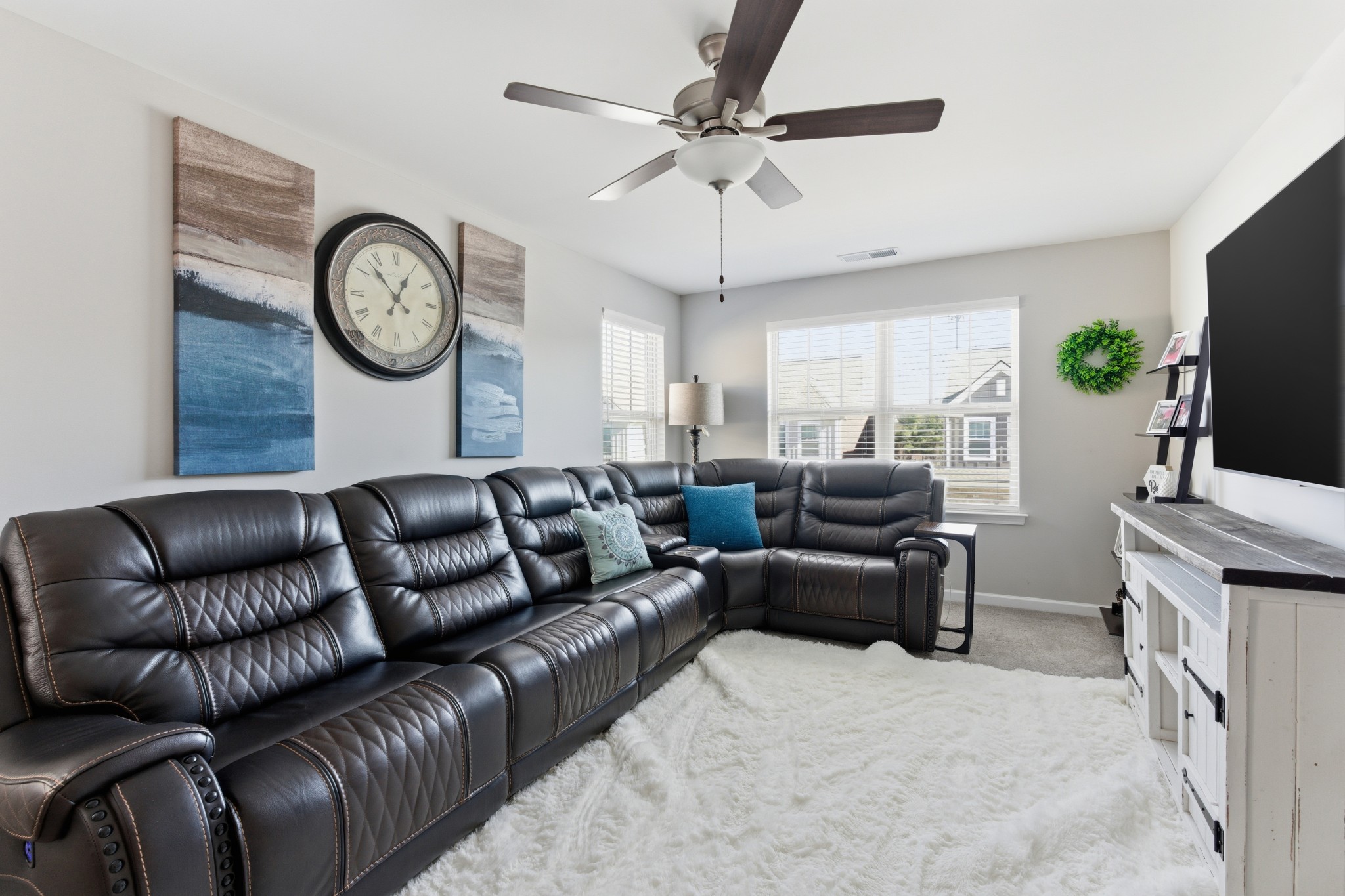 140 Rising Pvt Lane Gallatin, TN 37066 - Photo 13 of 29 a living room with furniture a clock and a flat screen tv