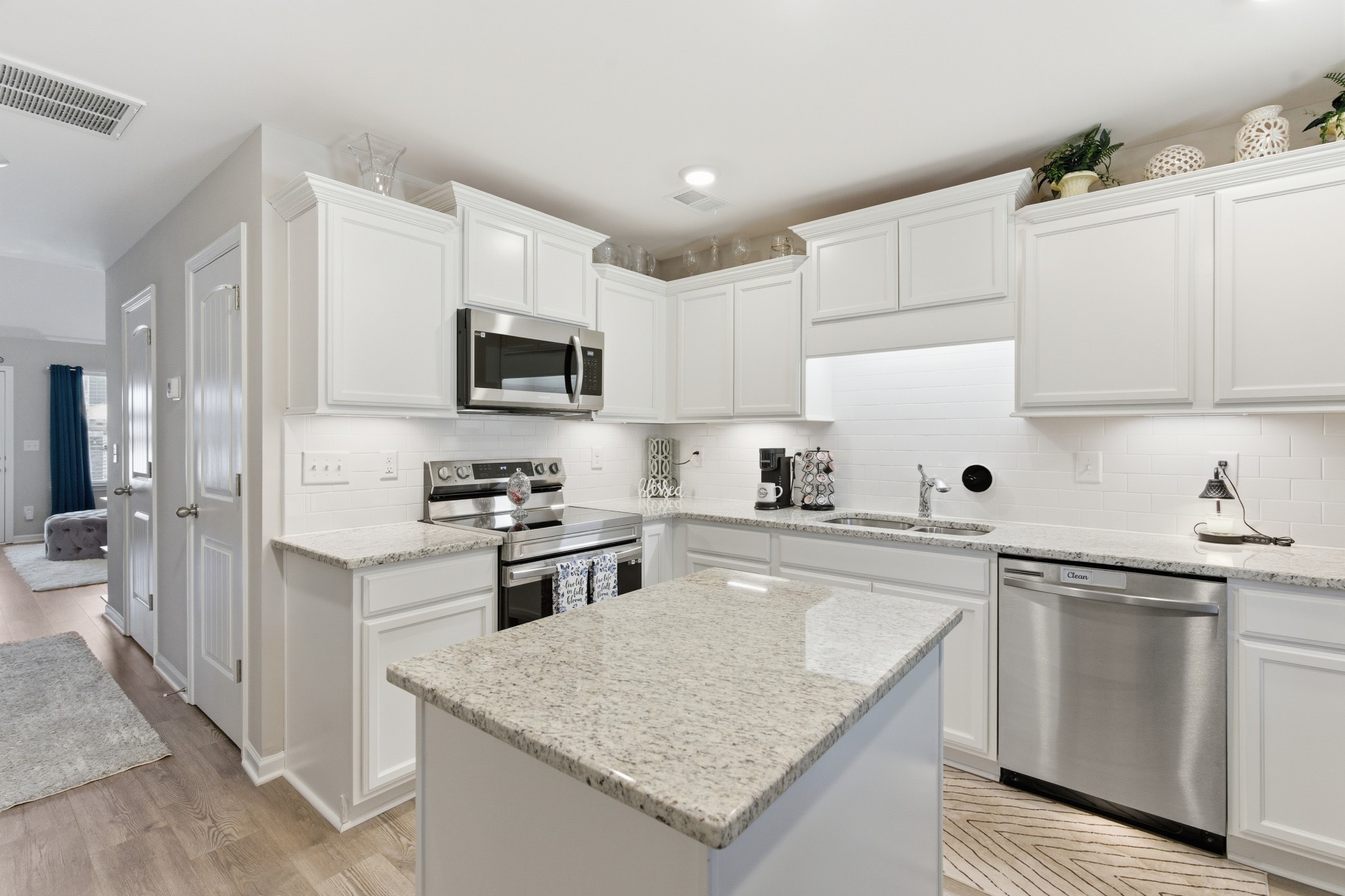 140 Rising Pvt Lane Gallatin, TN 37066 - Photo 6 of 29 a kitchen with granite countertop white cabinets and white appliances