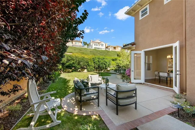 a view of a patio with couches table and chairs and potted plants