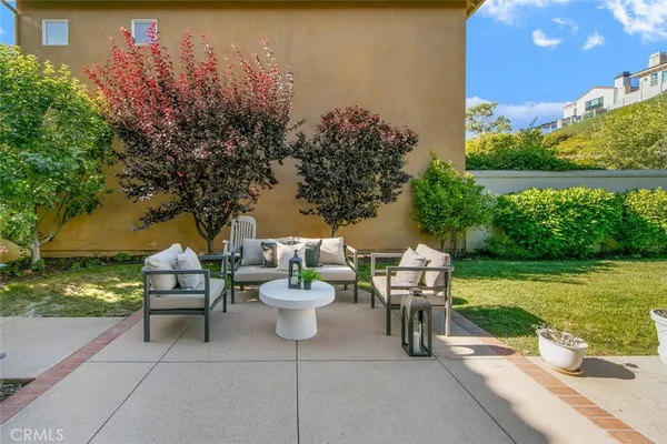 a view of a patio with a table and chairs