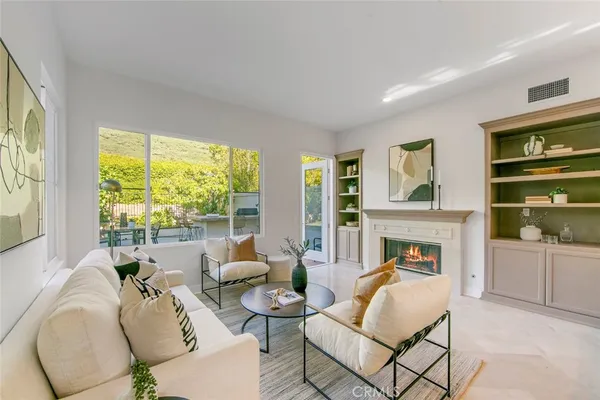 a living room with furniture fireplace and window