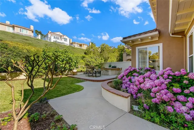 a view of a garden with flowers and trees
