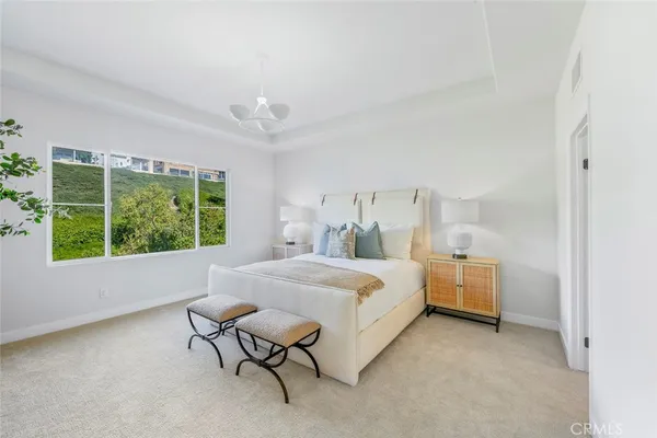 a bed room with a bed and a chair