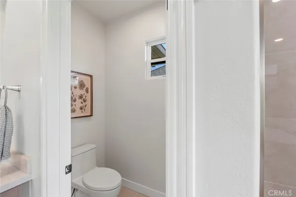 a white toilet sitting next to a shower curtain
