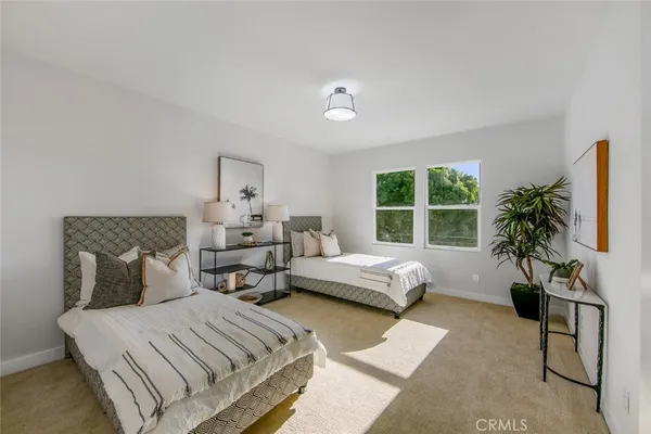 a bedroom with furniture and a large window