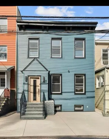 a front view of a house with stairs