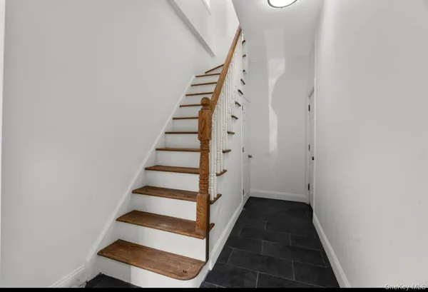 a view of entryway with stairs and wooden floor