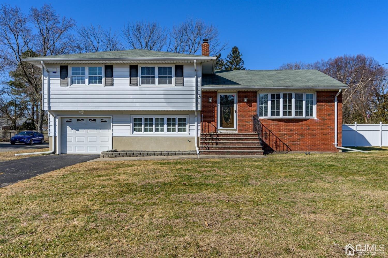 627 Lloyd Road Aberdeen, NJ 07747 - Photo 1 of 32 a front view of a house with a yard