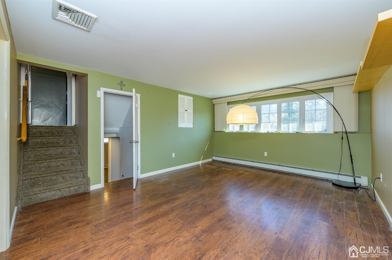 627 Lloyd Road Aberdeen, NJ 07747 - Photo 18 of 32 a view of wooden floor and windows in a room