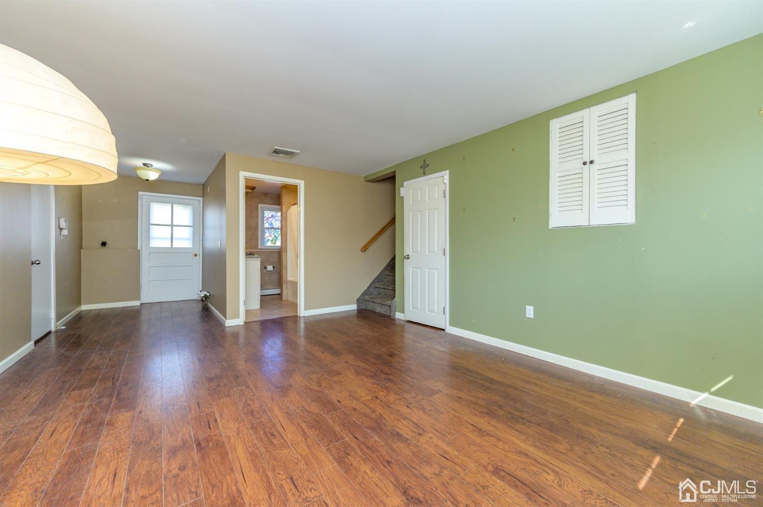 627 Lloyd Road Aberdeen, NJ 07747 - Photo 19 of 32 a view of an empty room with wooden floor and a window