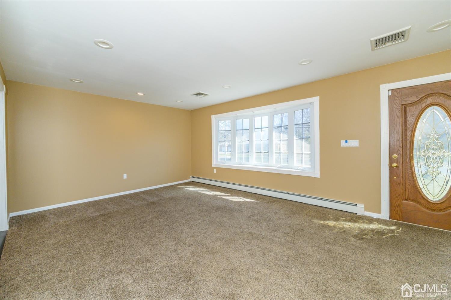 627 Lloyd Road Aberdeen, NJ 07747 - Photo 3 of 32 an empty room with windows and washer