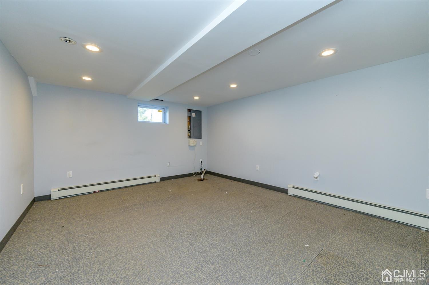 627 Lloyd Road Aberdeen, NJ 07747 - Photo 22 of 32 an empty room with a ceiling fan and window