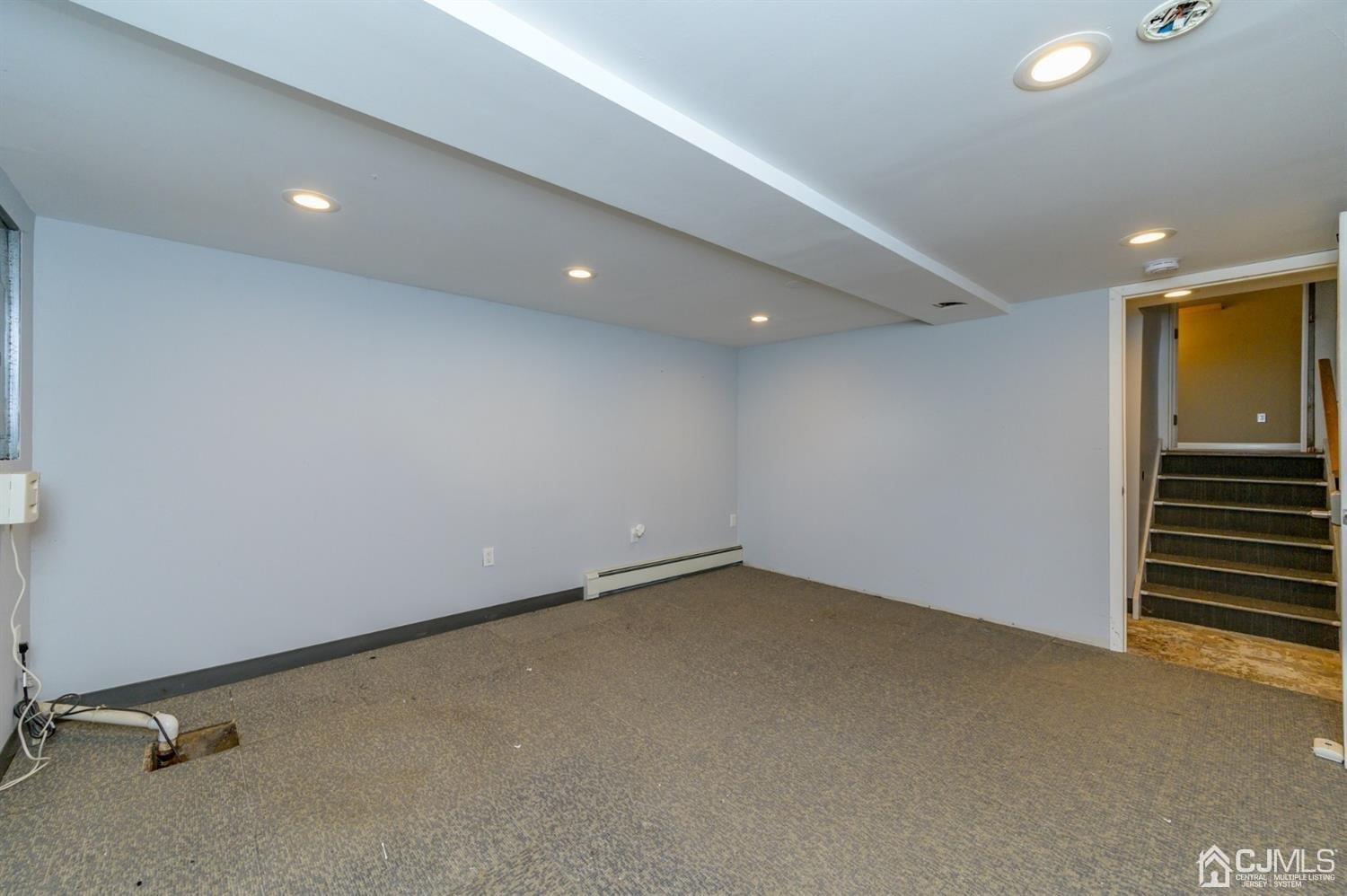 627 Lloyd Road Aberdeen, NJ 07747 - Photo 23 of 32 an empty room with a workbench