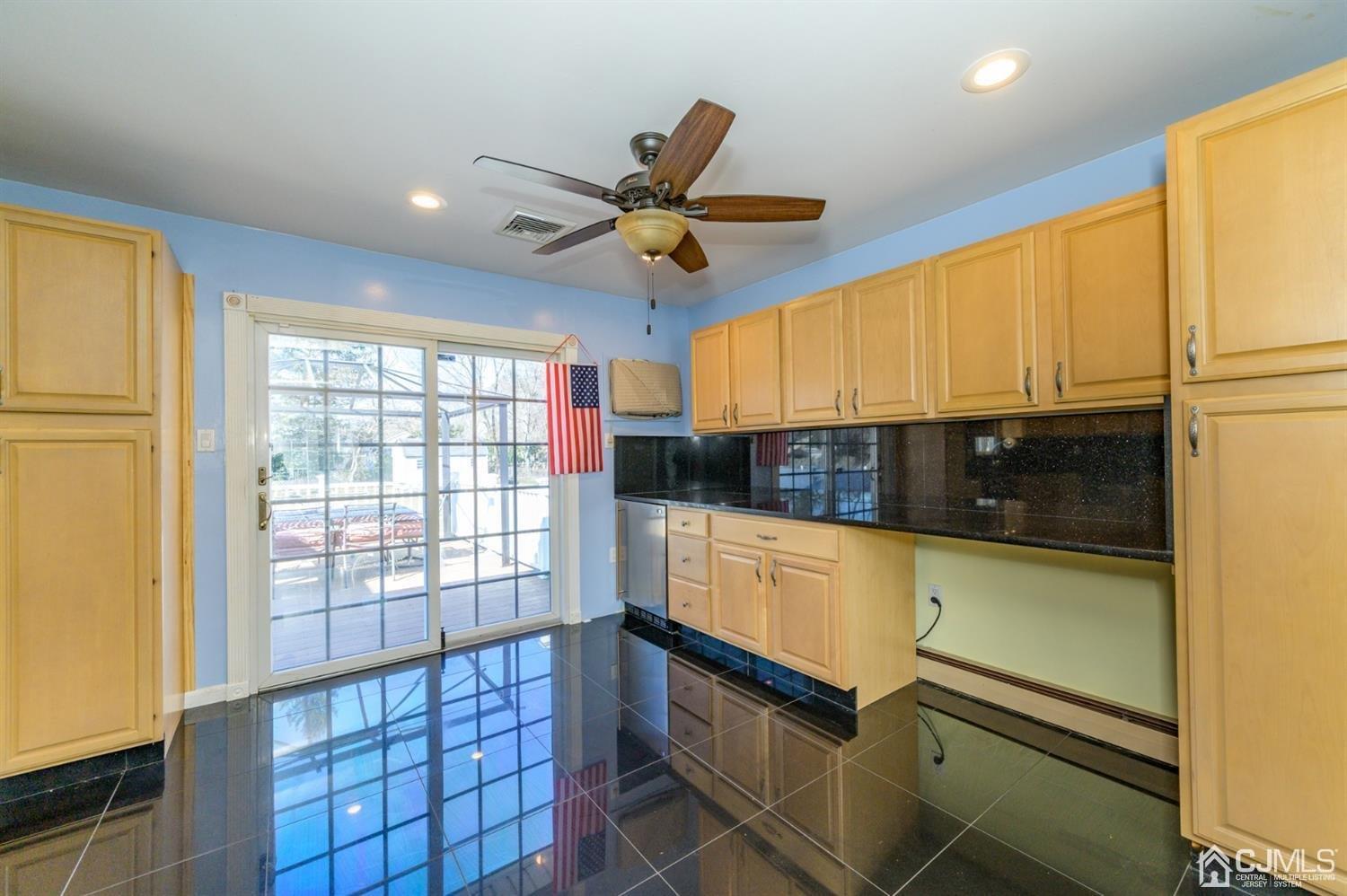 627 Lloyd Road Aberdeen, NJ 07747 - Photo 7 of 32 a kitchen with stainless steel appliances granite countertop a stove a sink and a microwave