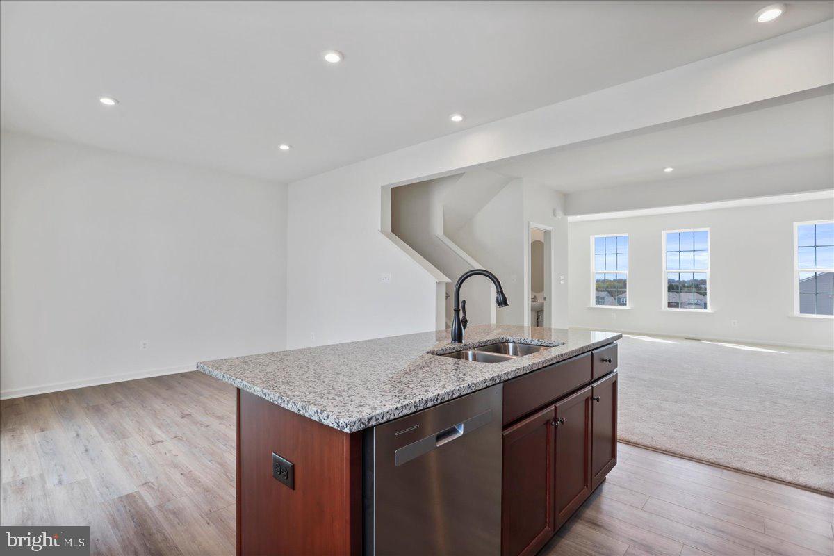 71 Stafford Place Falling Waters, WV 25419 - Photo 12 of 48 a kitchen with stainless steel appliances granite countertop a sink and dishwasher with wooden floor