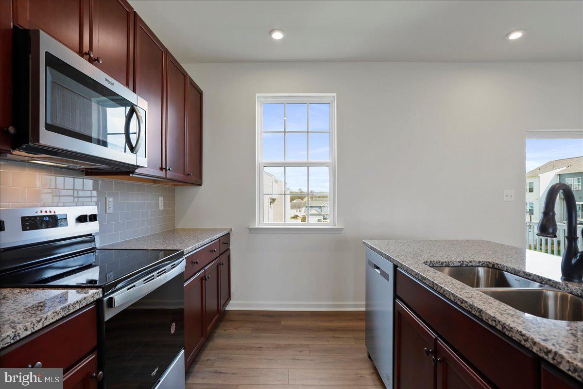71 Stafford Place Falling Waters, WV 25419 - Photo 13 of 48 a kitchen that has a sink wooden cabinets and stainless steel appliances