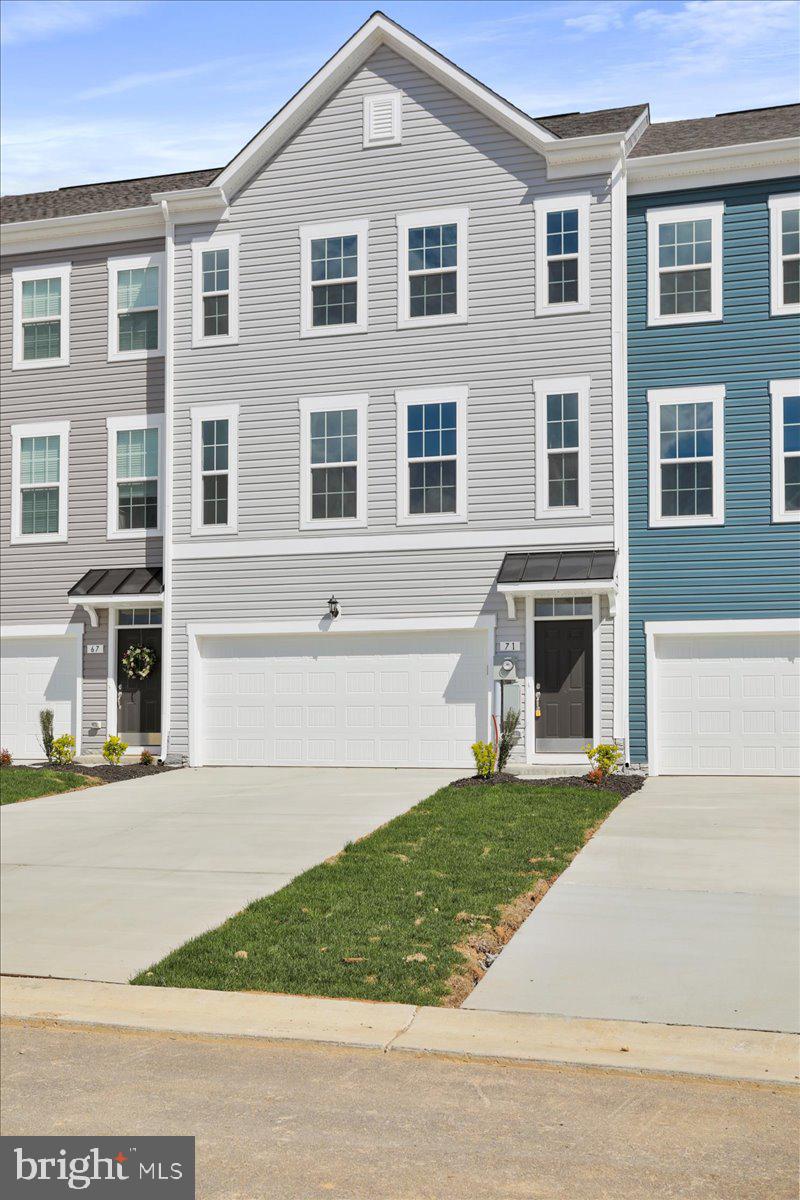 71 Stafford Place Falling Waters, WV 25419 - Photo 2 of 48 a front view of a house with a garden and trees