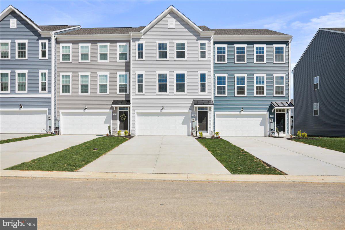 71 Stafford Place Falling Waters, WV 25419 - Photo 3 of 48 a front view of a house with a yard and garage