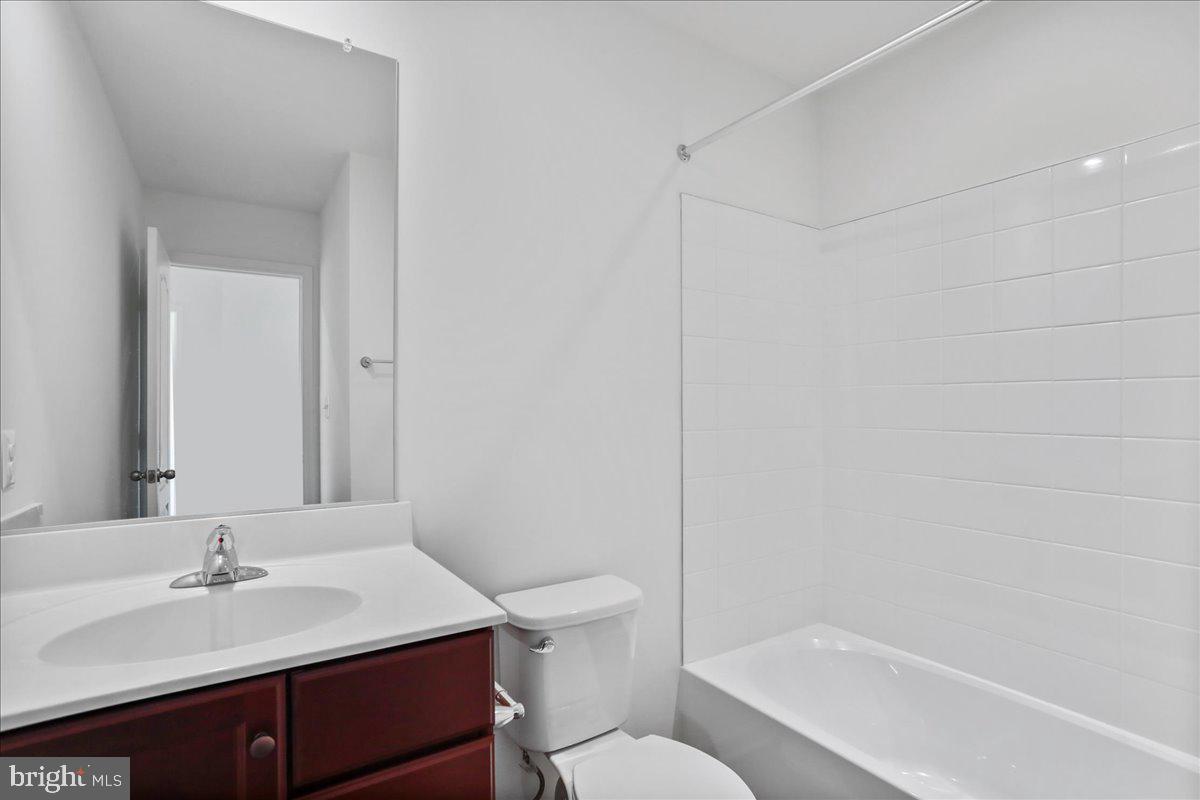 71 Stafford Place Falling Waters, WV 25419 - Photo 33 of 48 a bathroom with a granite countertop sink toilet a mirror and bathtub