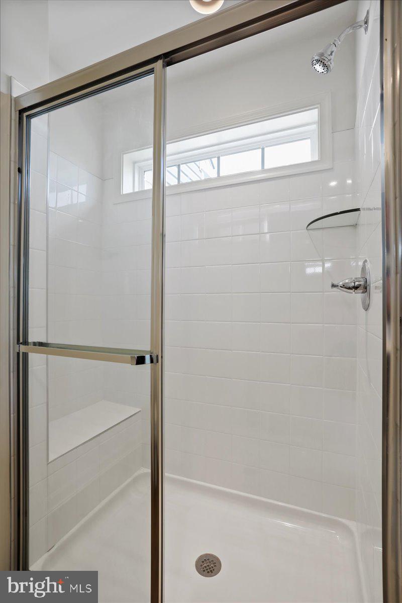 71 Stafford Place Falling Waters, WV 25419 - Photo 38 of 48 a bathroom with a glass shower door