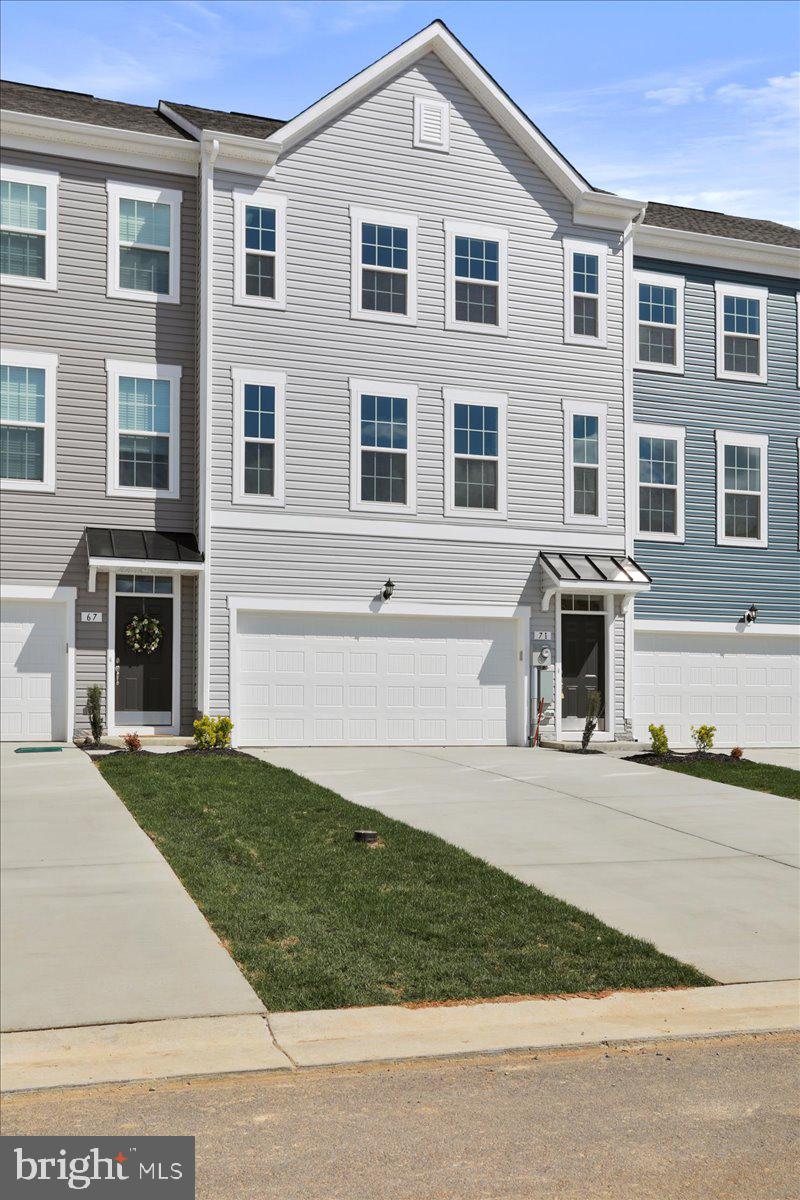 71 Stafford Place Falling Waters, WV 25419 - Photo 5 of 48 a front view of a house with a garden and trees